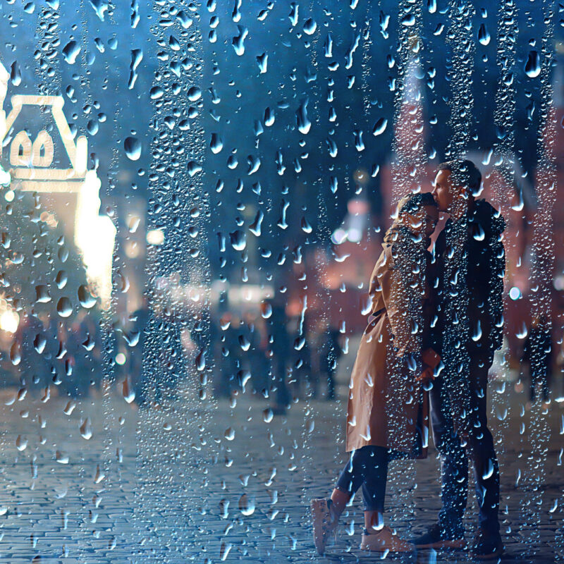 Mossbeard - All the almosts - A man and a woman embrace on a street corner in the rain,